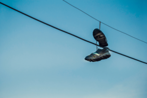 shoes dangling from a telephone line as is suggestive of a drug sale